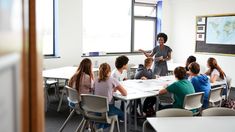 a group of children sitting at desks in a classroom