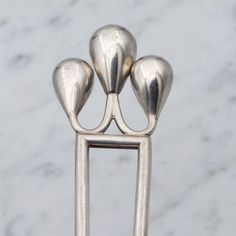 This antique Art Deco period sterling silver hair pin or comb features a stylized crown of three inverted drops and two long prongs.  Measurements: weight 17.5 grams, length just over 5 inches, width of top 28mm Condition: good antique condition with surface wear and some dings  Markings: not marked but has been tested and is guaranteed Please look closely at all photos and description and message me with any questions you might have, or to request a video.   Please be aware that because of close-up photography, some items may appear bigger on your screen than they are in real life.  This is why I give full measurements and a hand for comparison on all of my items.   If you do not absolutely love your purchase, please message me to arrange a return and full refund. Silver Hair Pin, Close Up Photography, Wedding Hair Pins, Art Deco Period, Antique Art Deco, Silver Hair, Wedding Hair Accessories, Hair Pins, Wedding Accessories