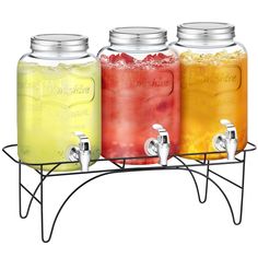 three mason jars filled with different colored drinks