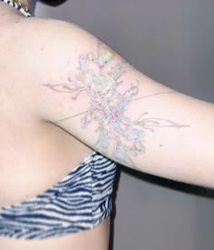 a woman with a flower tattoo on her left arm and right arm behind her back