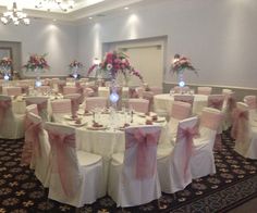 the banquet room is set up with pink and white linens