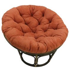 a round chair that is made out of wood and has an orange cushion on it