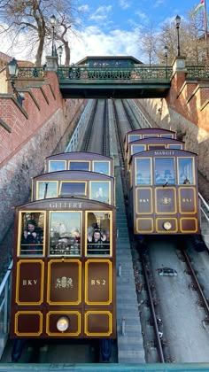 two trolleys going down the tracks in an amusement park