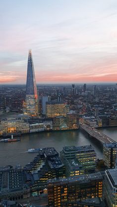 an aerial view of the city at dusk, including the shardling building and river thames