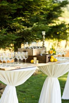 the table is set up with wine glasses and lemons for an elegant wedding reception