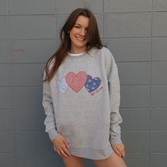 This precious crewneck is sure to be the cutest piece for your summer wardrobe. This oversized fit crewneck will have three patchwork hearts in blue & red shades, with your sorority name embroidered in script next to the hearts. Fully embroidered design, all crews will have the same fabric & pattern order. This crewneck is an oversized, relaxed fit. The model is a size 4, wearing a size medium. Order your normal size for an oversized fit, but a size down if you want it to fit closer to a classic unisex crew. Bulk order pricing available, reach out to us via email info@thelettermarket.com to get started on a custom order! SIZE CHART: Sorority Sweatshirt Design Cricut, Embroidered Sorority Shirt, Sorority Patchwork Shirt, Sorority Embroidered Sweatshirt, Embroidered Sorority Sweatshirts, Embroidered Crewneck Diy, Patchwork Shirt Ideas, Patchwork Crewneck, Sorority Names