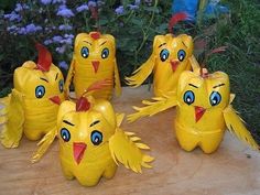 five yellow plastic birds sitting on top of a wooden table