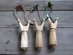 four toothbrushes are lined up next to each other on a wooden table with two handles