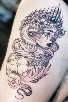 a woman's thigh with a skull and flowers tattoo on the side of her leg