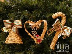 two christmas ornaments are hanging on a tree together, one is shaped like a heart and the other has a bow