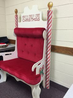 a red and white chair with candy canes on the back is sitting in a room