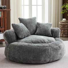 a large round chair sitting on top of a carpeted floor next to a window