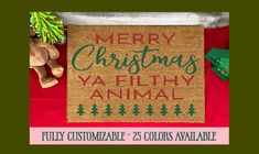 a merry christmas ya filthy animal door mat with teddy bear and pine trees on it