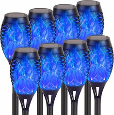 six blue solar powered garden lights on black poles