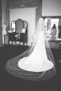 the bride is getting ready to walk down the aisle in her wedding dress and veil