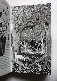 an open book with black and white drawings on it's pages, showing a deer in the woods