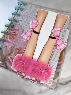 an open book with a drawing of a woman's legs and pink shoes on it