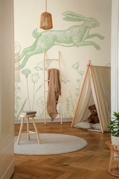 a child's room decorated in green and white with an animal mural on the wall