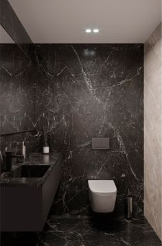 a black and white bathroom with marble walls