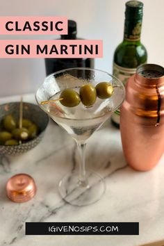 the classic gin martini is served in a coupe glass with an olive garnish