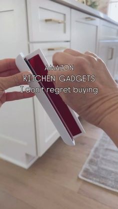 a person holding an amazon kitchen gadgets box in their hand