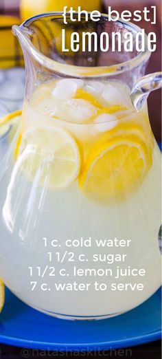 a pitcher filled with lemonade sitting on top of a blue plate