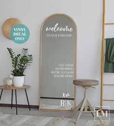 a room with a mirror, stool and plant on the floor in front of it