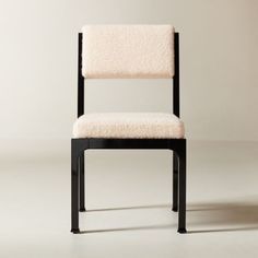 Inspired by classic Hollywood Regency style and the minimalism of Italian midcentury, the Mireille upholstered dining chair by goop stands out with its understated details. Finished with a high-gloss black lacquer, solid beech wood shapes the chair's angled silhouette, softened by custom ivory boucle. Inspired by high-end Parisian textiles, wool and cotton yarns are blended for softness and texture, drawing you in with its delicate irregularity. andamp;quot;We leaned into complex materiality for Ivory Dining Chairs, Woven Dining Chairs, Gold Furniture, Fabric Sectional Sofas, Unique Sofas, Leather Sectional Sofa, Formal Dining Tables, Woven Chair, Grey Dining