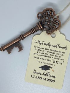 an antique key with a graduation message attached to it