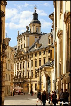 people are walking around in an old european city