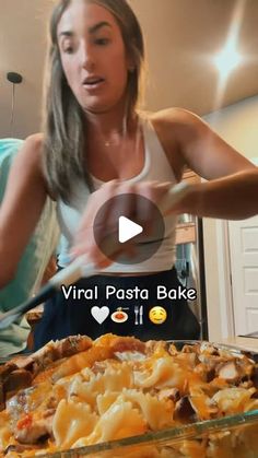 a woman is making a pizza in the kitchen