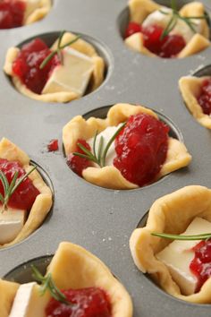 small pastries with strawberries and cheese in a muffin tin