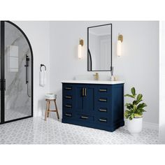 a bathroom with a blue vanity and mirror