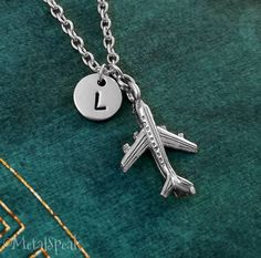 "This listing is for a personalized airplane pendant keychain with a hand-stamped initial charm. We can also make this into a necklace instead, just choose your chain length from the drop-down menu. You will be able to choose between a key ring, link chain, bangle bracelet, or ball chain when checking out. You will also be able to choose your initial! :) **Please see the second picture for scale. This is a SMALL and lightweight charm. The initial charm measures 3/8\". - - - - - - Sign up for our Relationship Travel, Gift Long Distance Relationship, Airplane Jewelry, Airplane Pendant, Plane Necklace, Travel Keychain, Airplane Necklace, Airplane Gifts, Small Plane