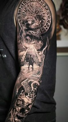 a man's arm with tattoos on it