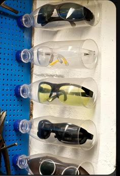 several pairs of sunglasses are lined up on a shelf