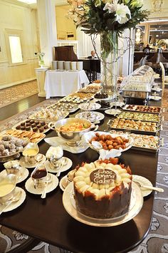 a buffet table filled with desserts and pastries