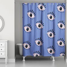 a blue shower curtain with an eye pattern