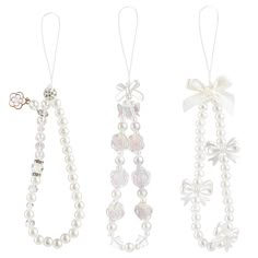 three necklaces with bows and pearls on them