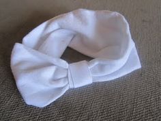 a close up of a white headband on a carpet