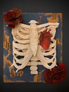 a piece of art that has been made to look like a human skeleton with a heart on it