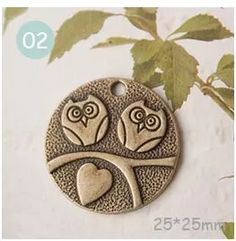 two owls sitting on a tree branch with hearts in their beaks and the number 20