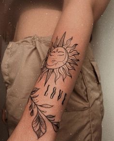 a woman's arm with a sun and leaves tattoo design on it that says i love you