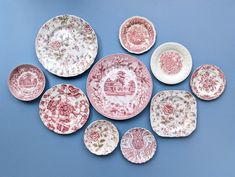 several plates with different designs on them are arranged in the shape of a flowered heart