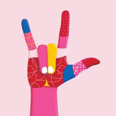 a person's hand with two fingers painted in different colors and shapes, on a pink background