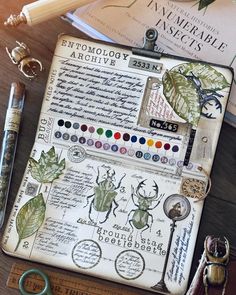 an old book with bugs on it next to some pens and pencils