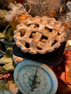 an old fashioned pie sitting on top of a scale