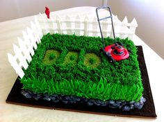 a lawn mower sitting on top of a green cake