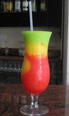 a colorful drink sitting on top of a counter