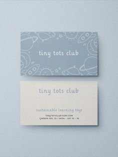 two business cards sitting side by side on top of each other with the words tiny tots club printed on them